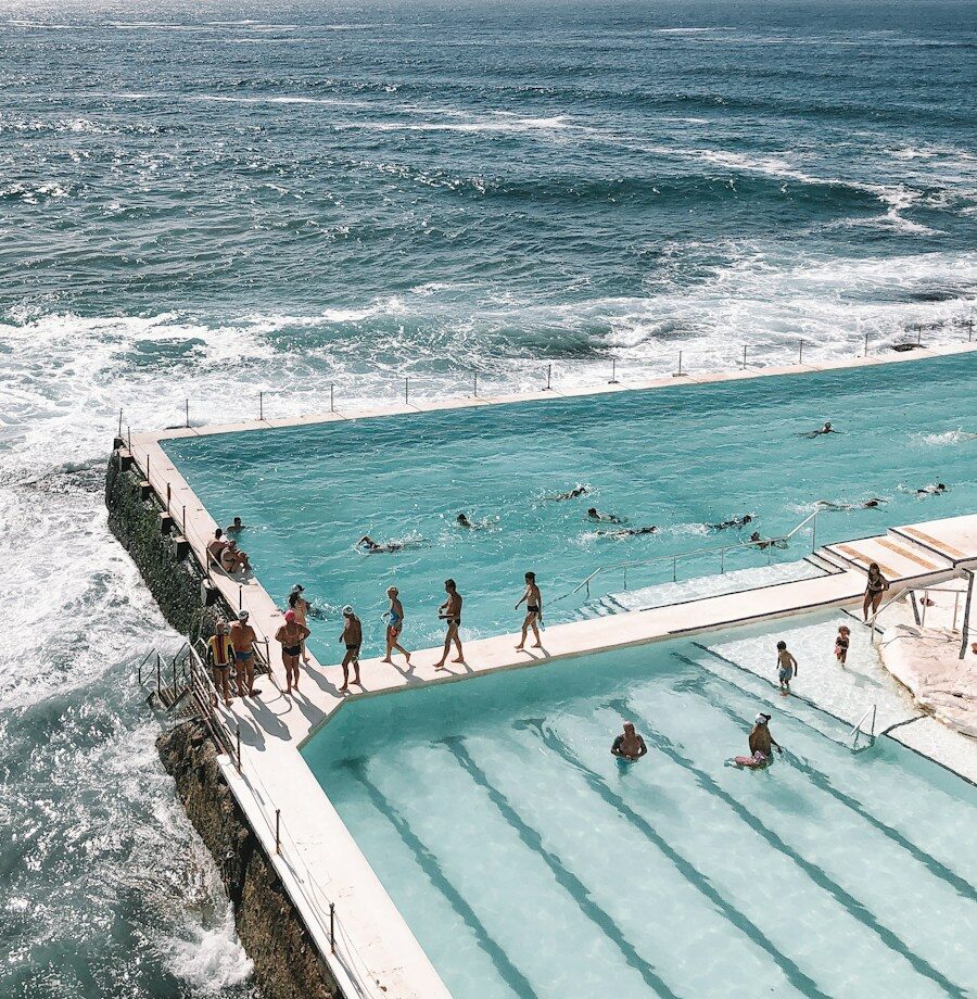 people swimming on pool near sea